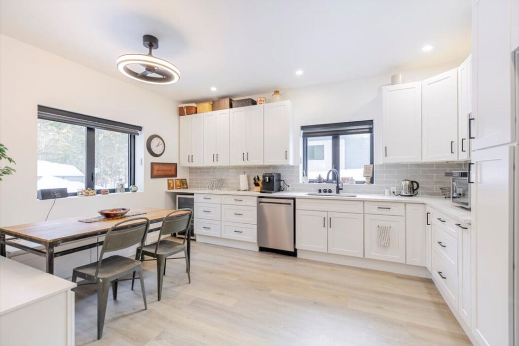 breakfast nook with large windows to forest at the back of property.