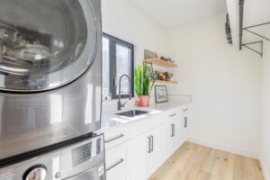 bright laundry room with a view with plenty of storage